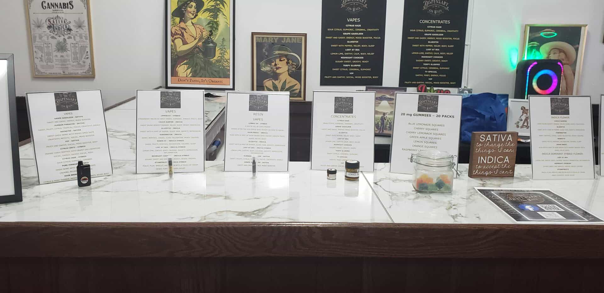 Cannabis dispensary counter with vape and gummy products.