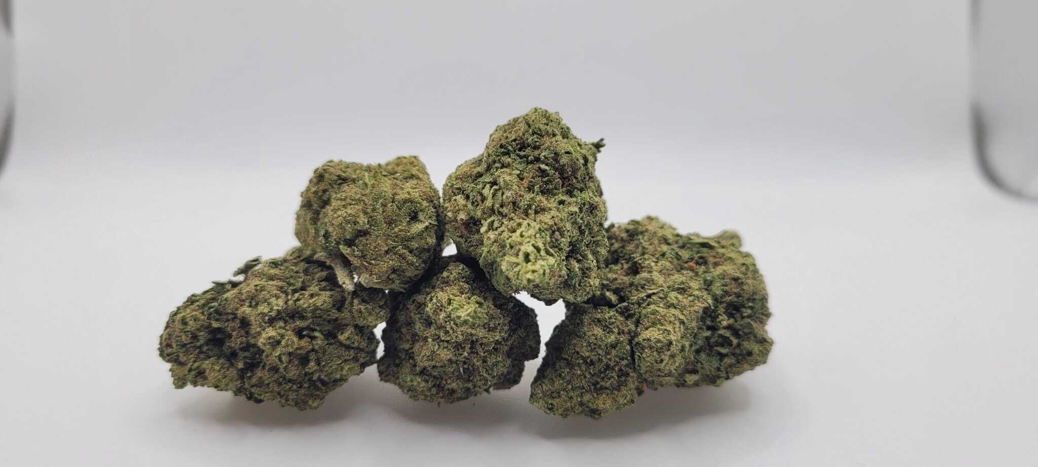 Close-up of cannabis buds on white background.