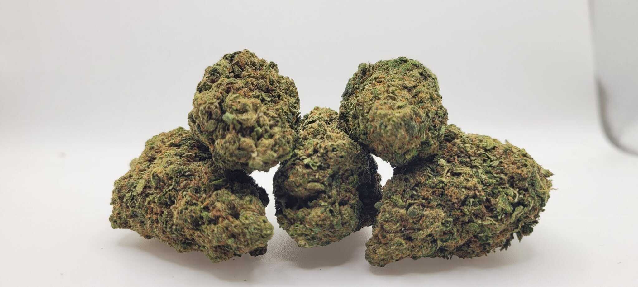 Close-up of cannabis buds on white background.