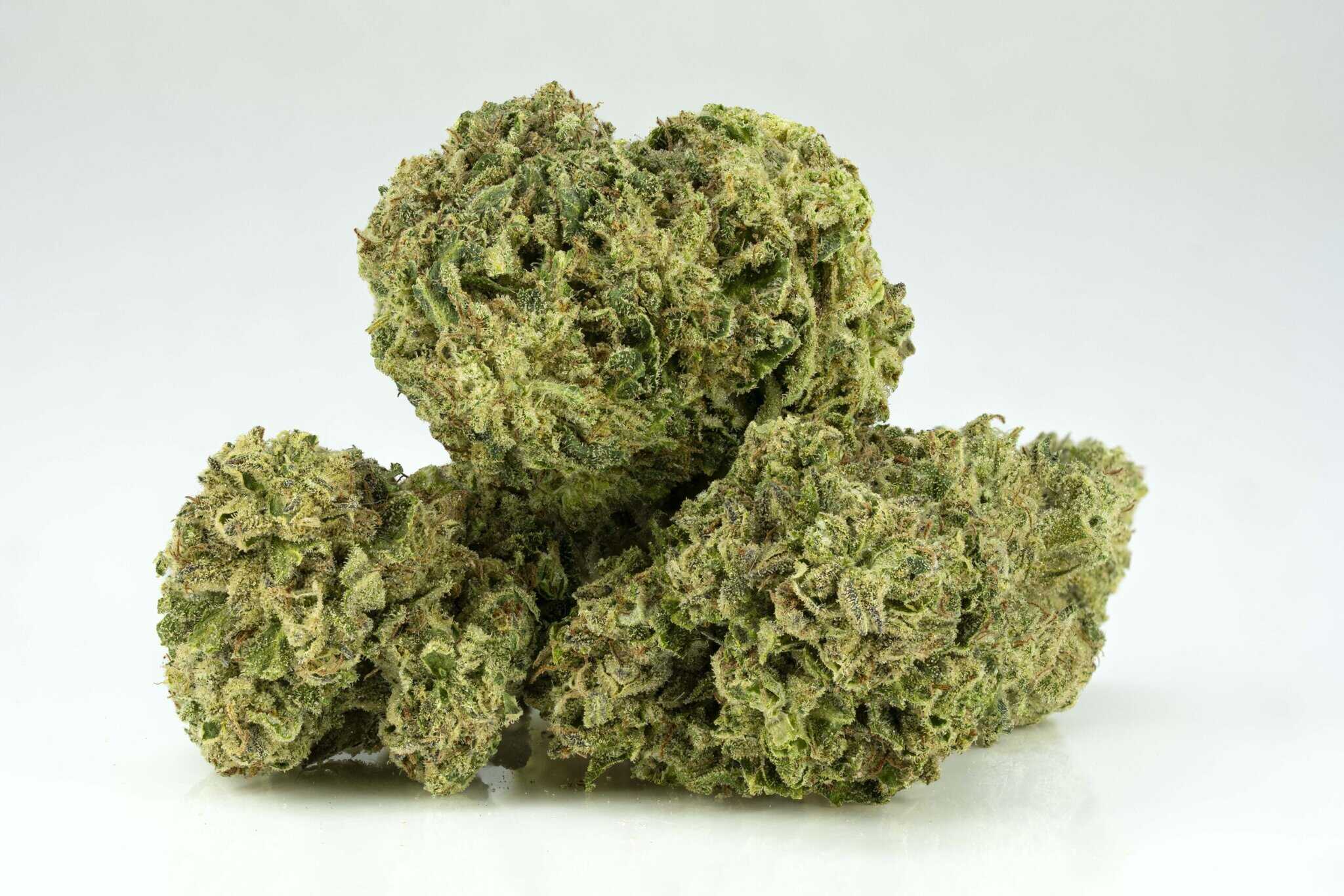 Close-up of cannabis buds on white background.