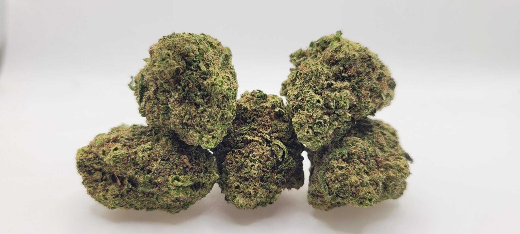 Close-up of cannabis buds on white background.