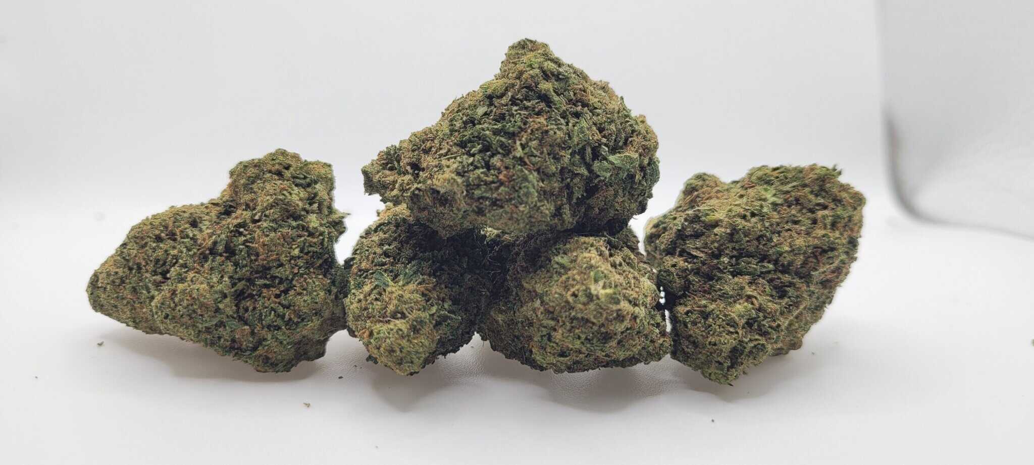 Close-up of cannabis buds on white background.