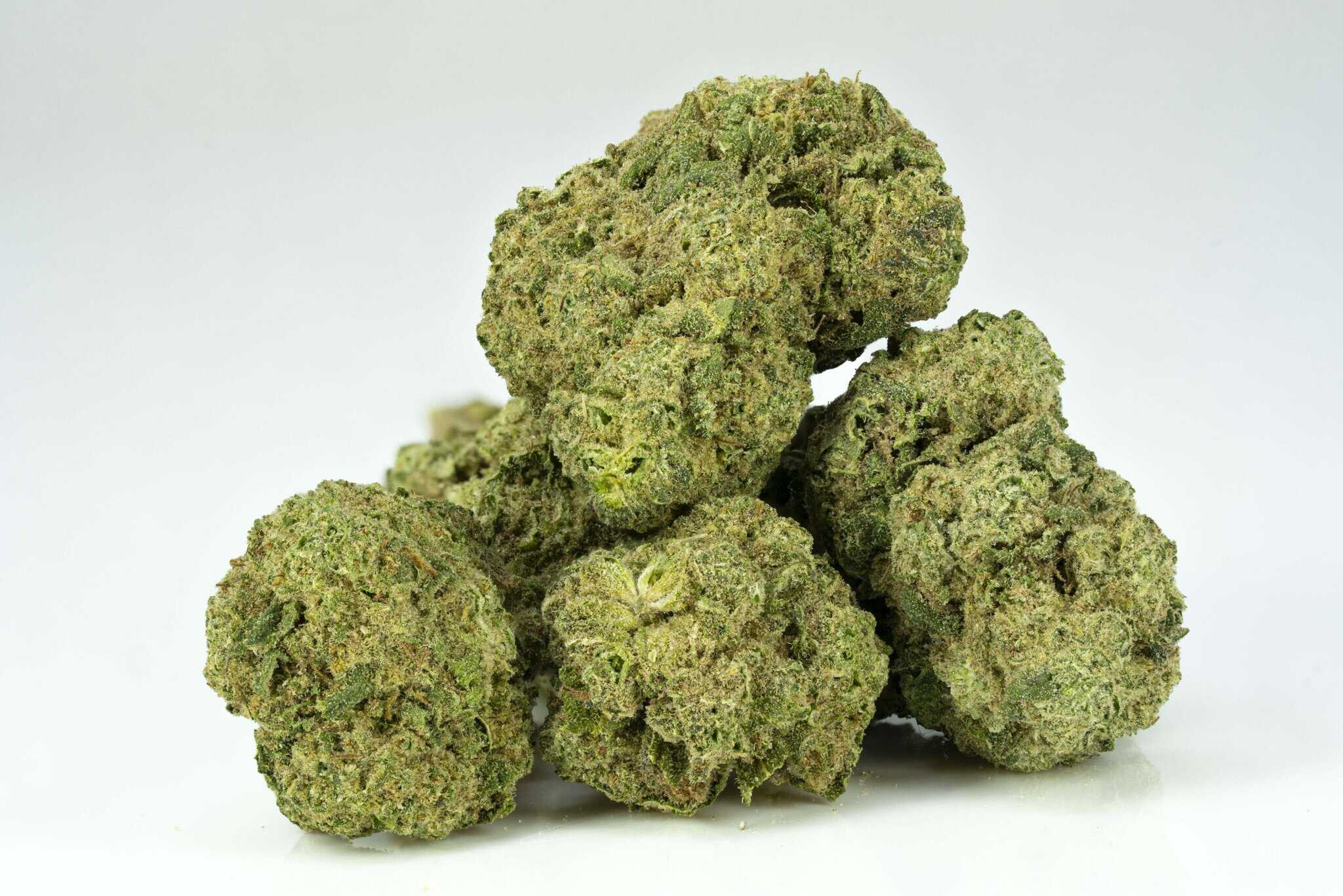 Close-up of cannabis buds on white background.