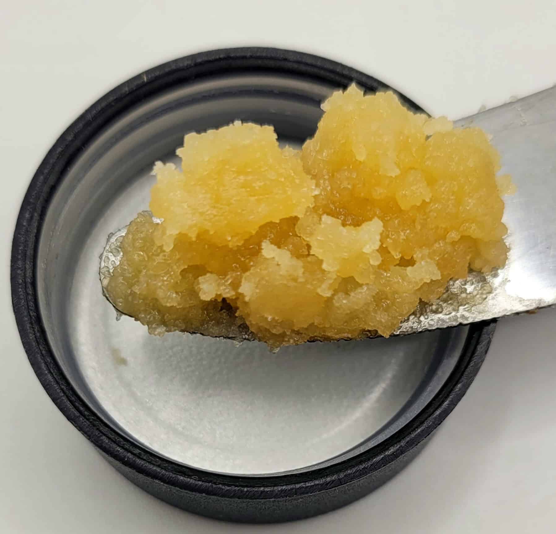 Yellow cannabis concentrate on metal tool.