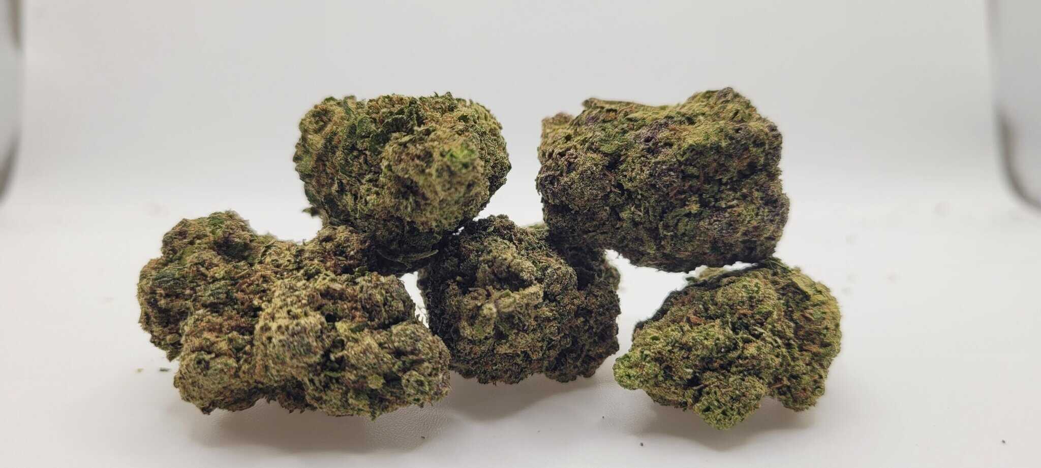 Close-up of cannabis buds on white background.
