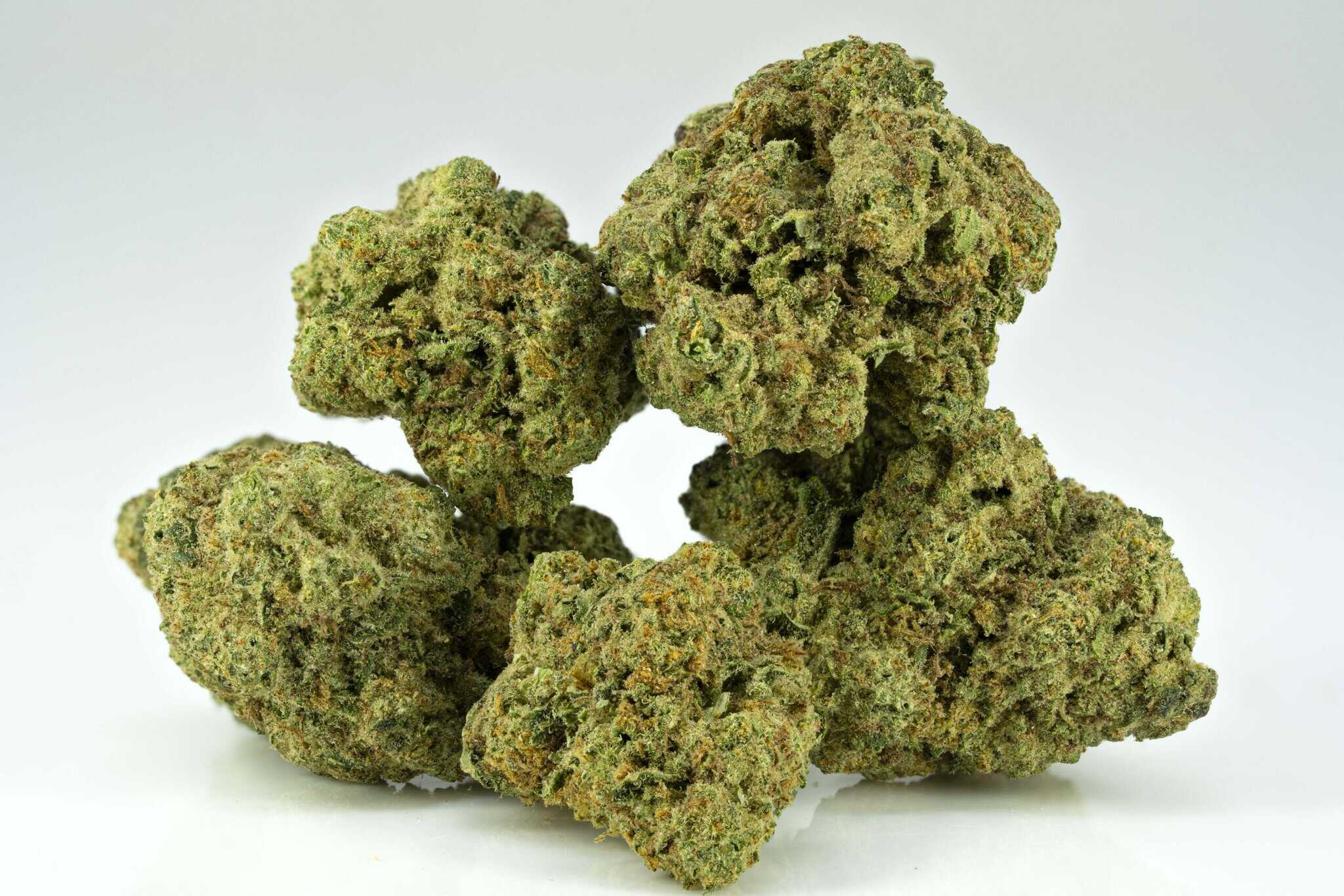 Close-up of cannabis buds on white background.