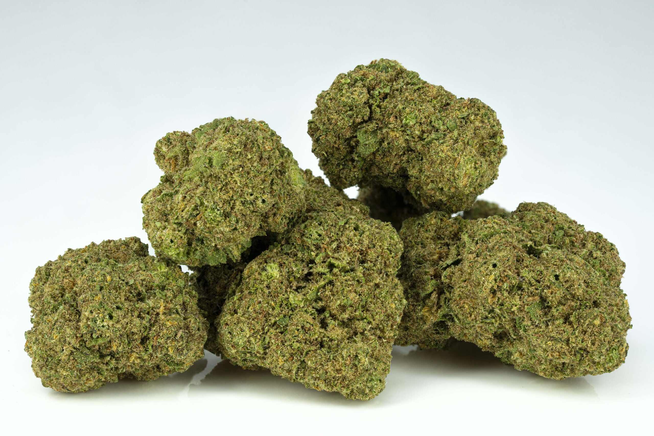 Close-up of cannabis buds on white background.