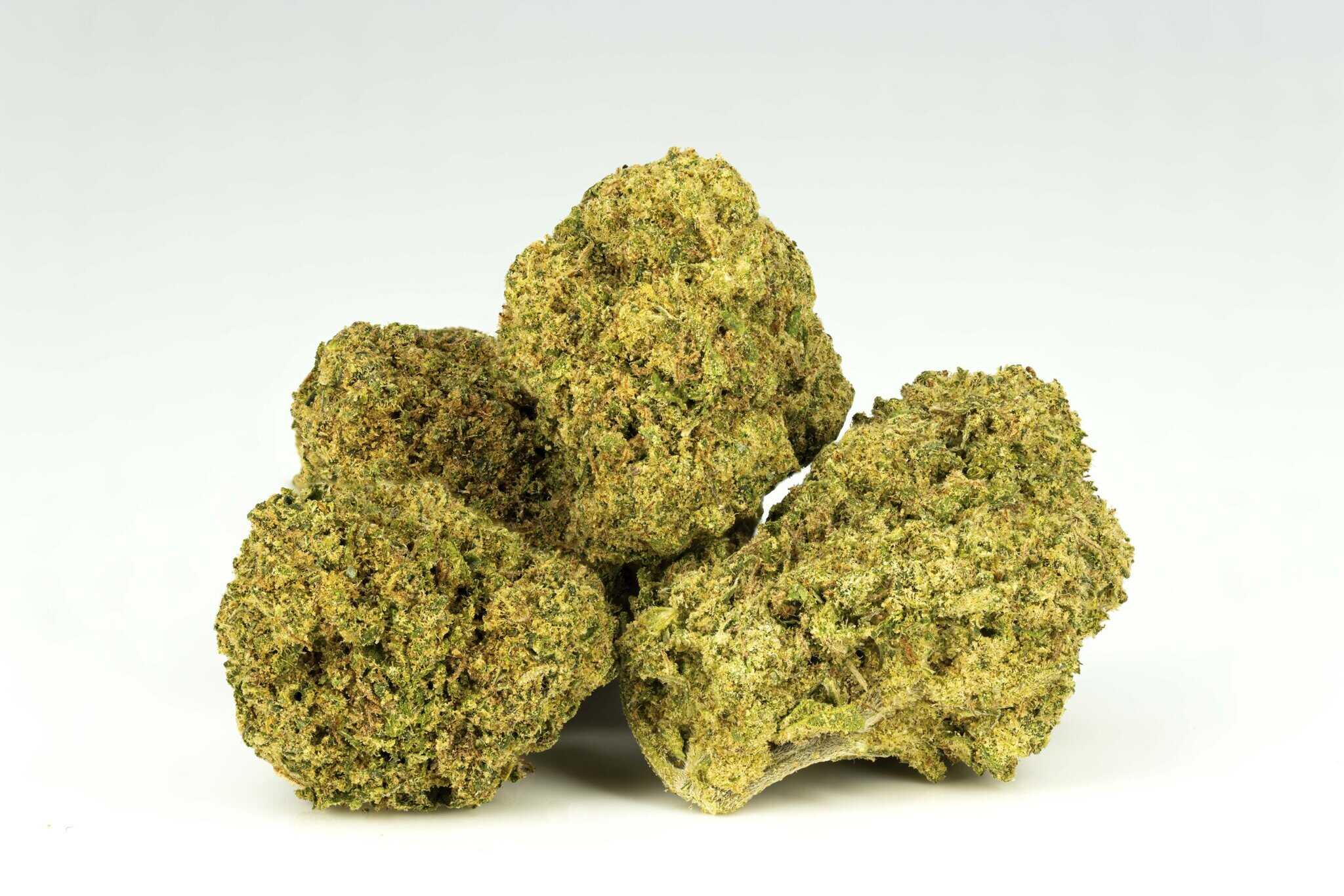 Four cannabis buds on white background.